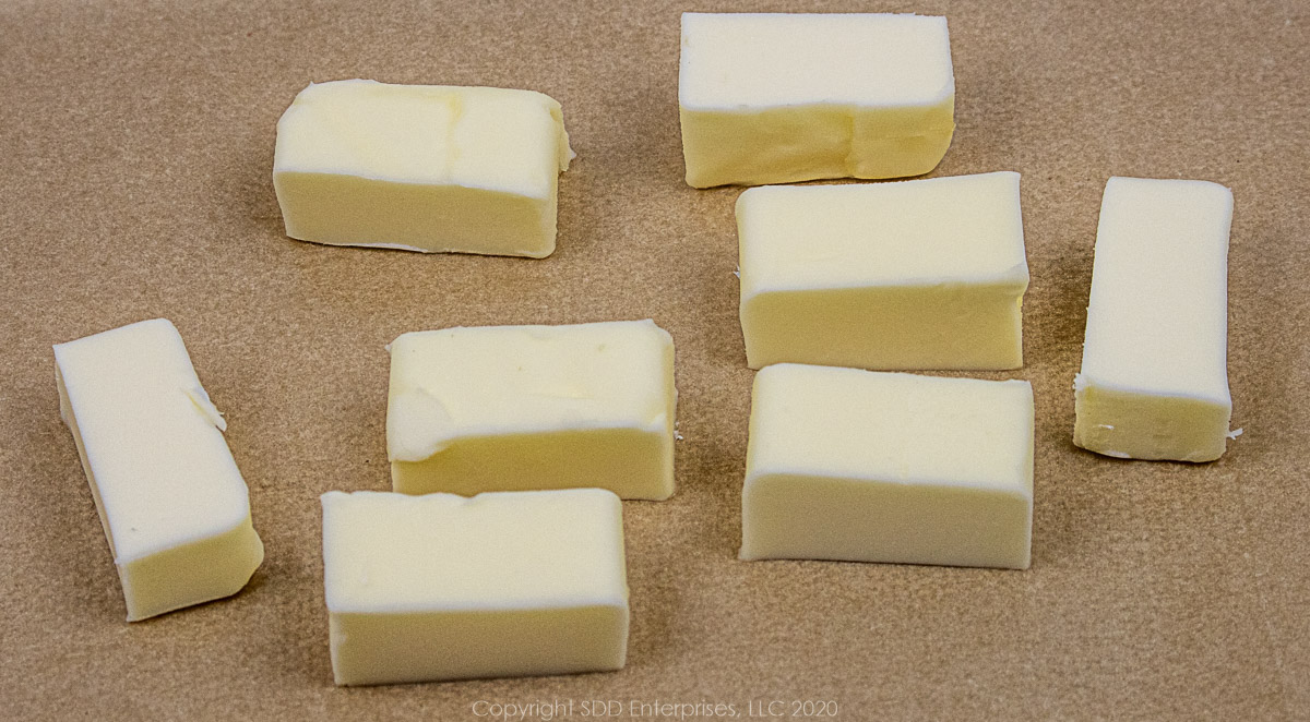 butter cut into ½ tablespoon pieces on parchment paper