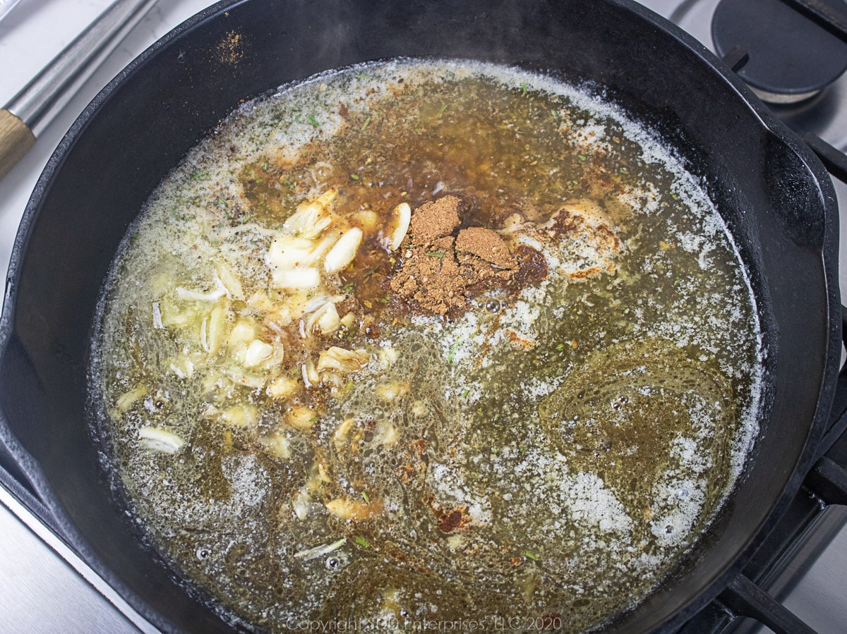 butter with worchestershire and lemon sauces and herbs and spices in a cast iron skillet