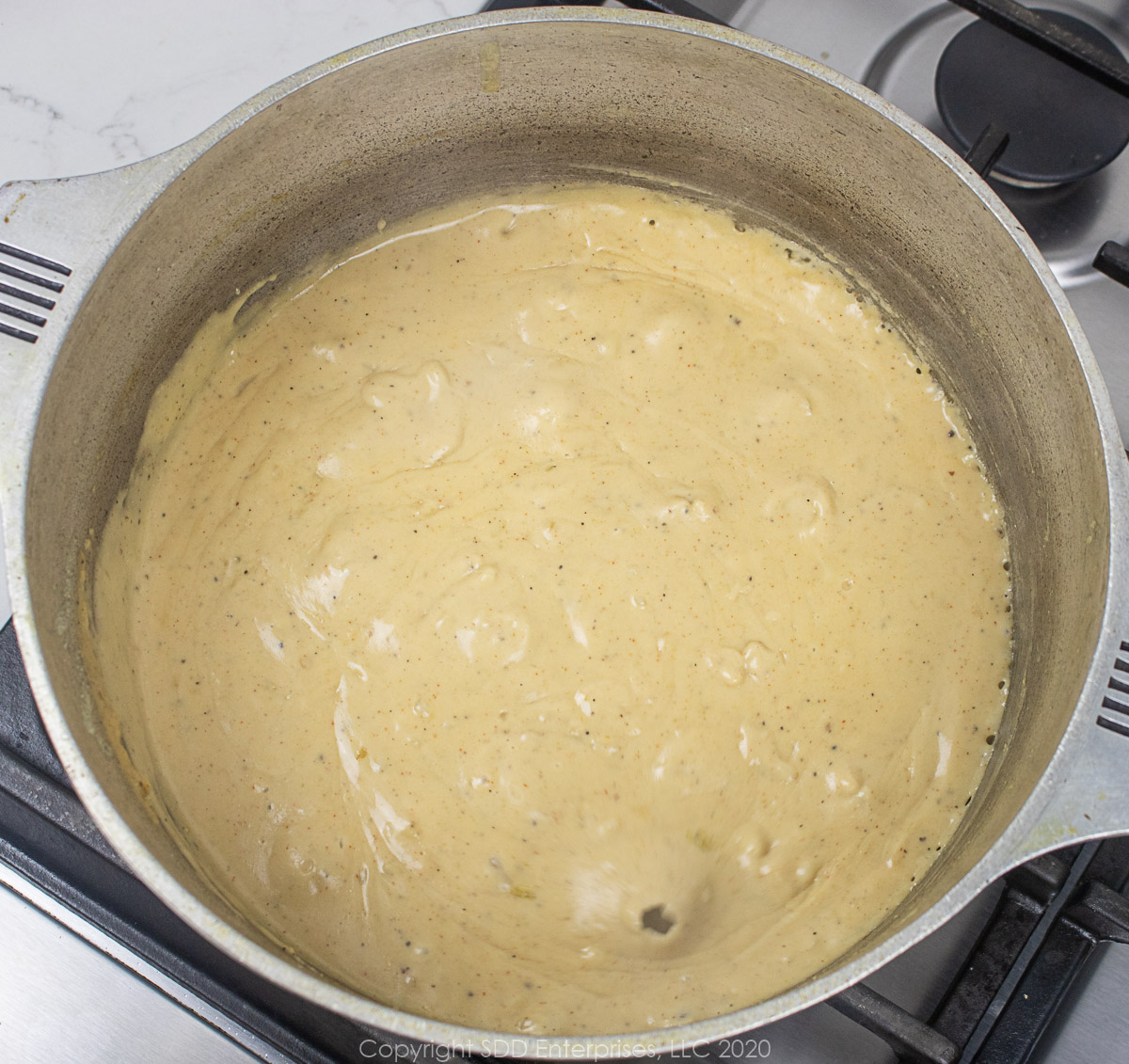 smooth cheese sauce in a dutch oven