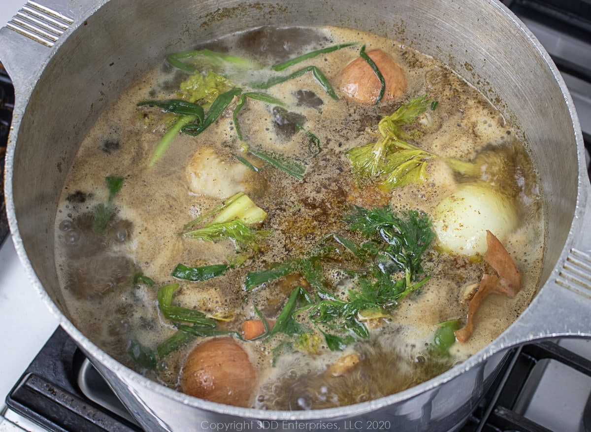 simmering chicken stock in a stockpot