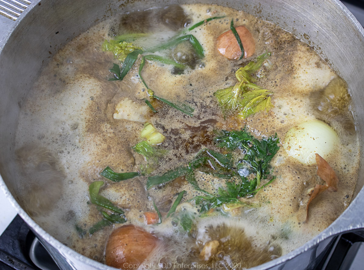 ingredients for chicken stock simmering in a stockpot