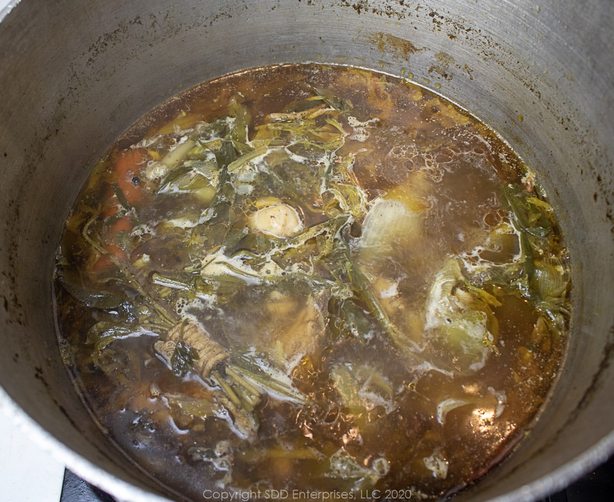simmering chicken stock in a stockpot