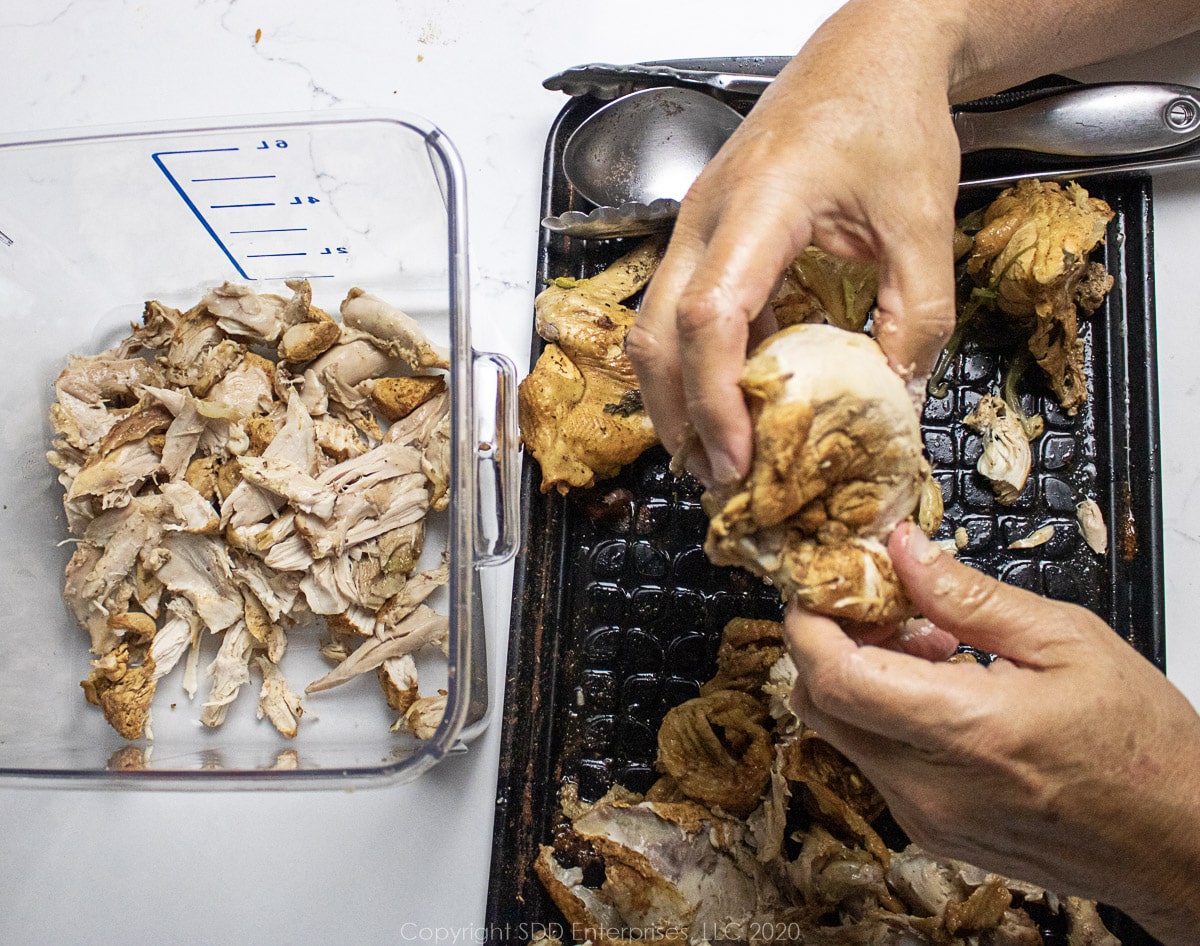 seperating the skin and bones from the chicken meat