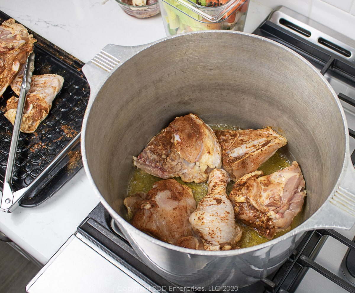 chicken browning in a stock pot