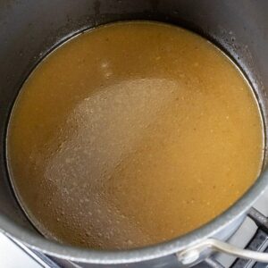 homemade chicken stock in a stockpot