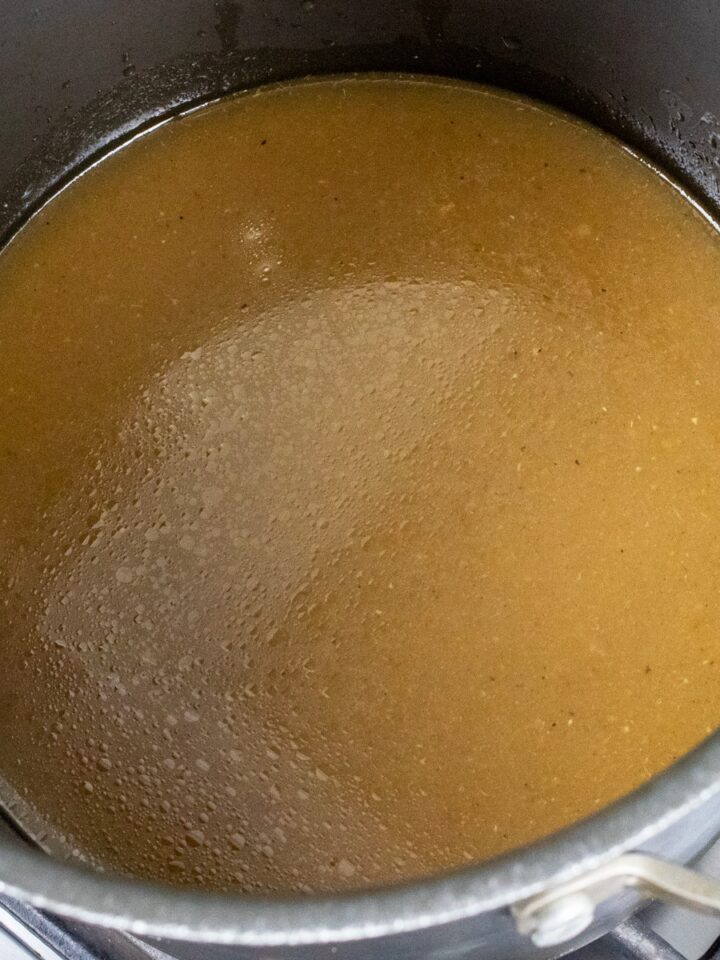 homemade chicken stock in a stockpot