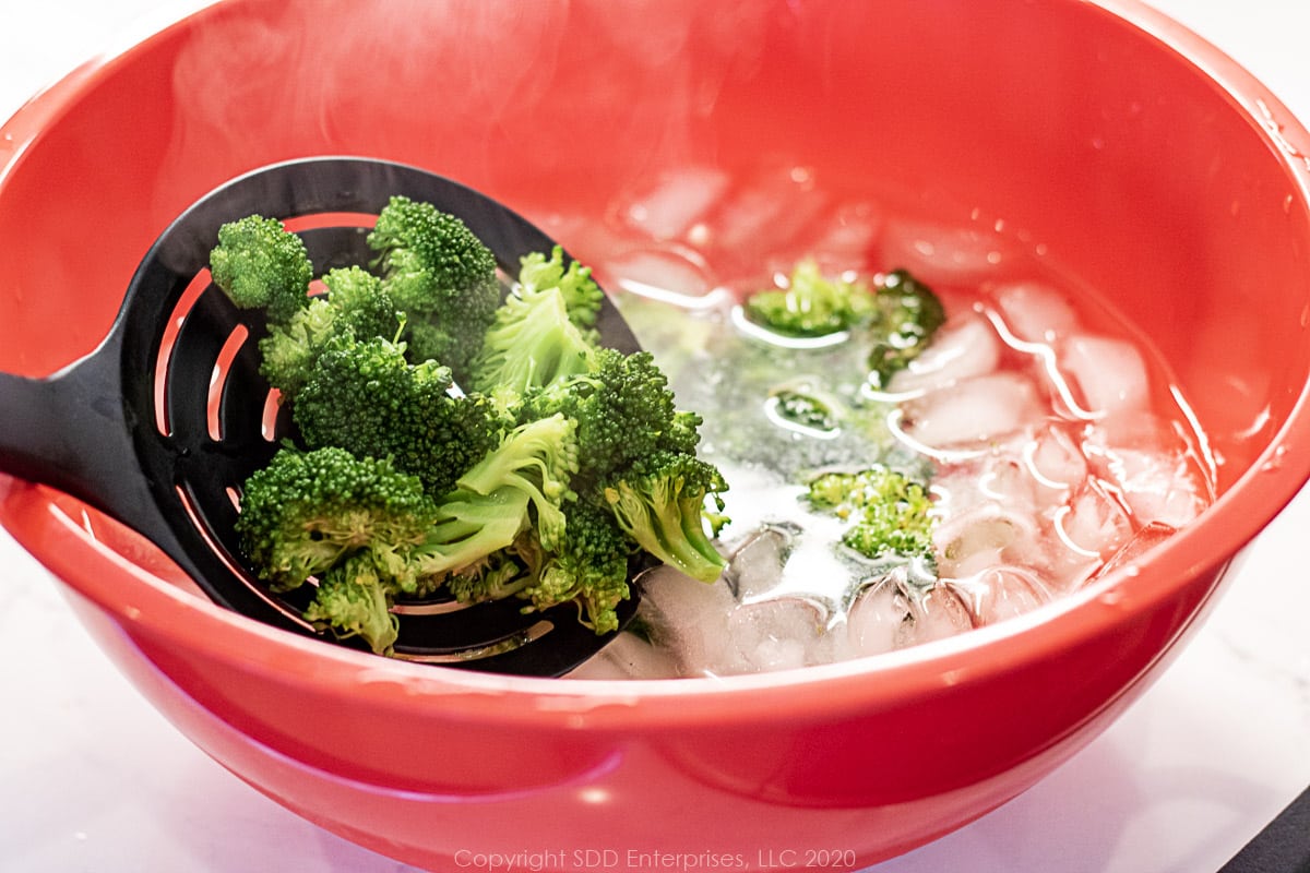 placing broccoli florets into an ice bath