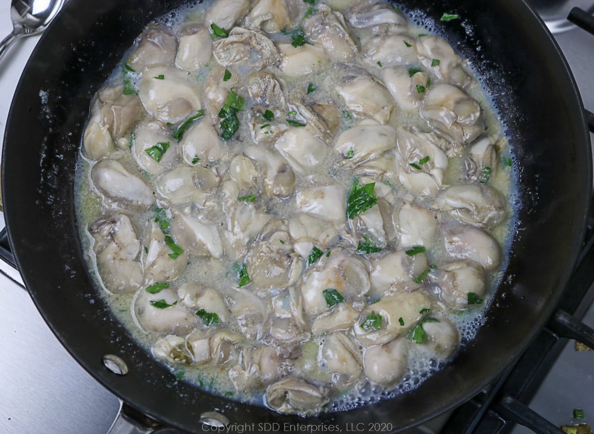 sauteing fresh oysters in a skillet