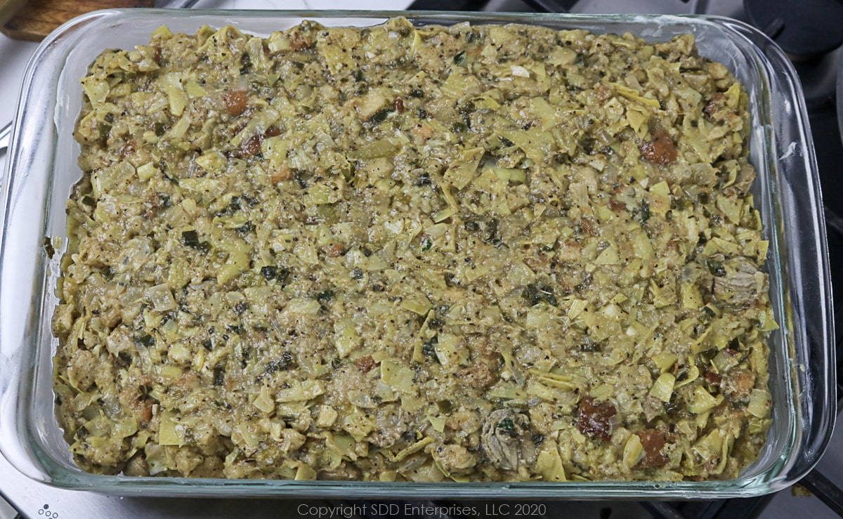 oyster artichoke dressing in a baking dish before baking