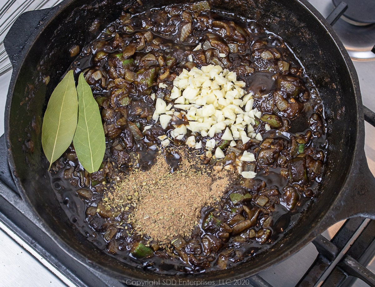 garlic and herbs and spices added to roux in a Dutch oven