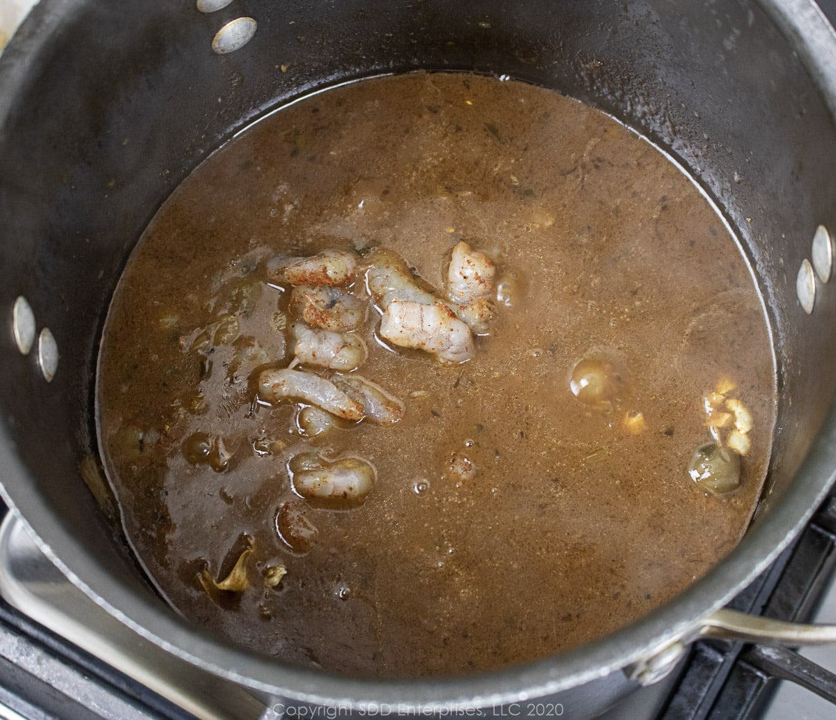 shrimp added to seafood gumbo in a stockpot