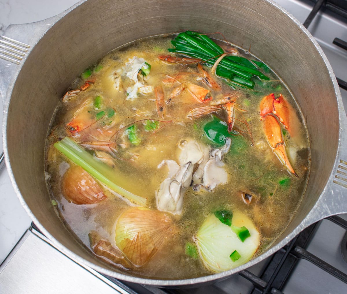 seafood stock simmering in a stockpot