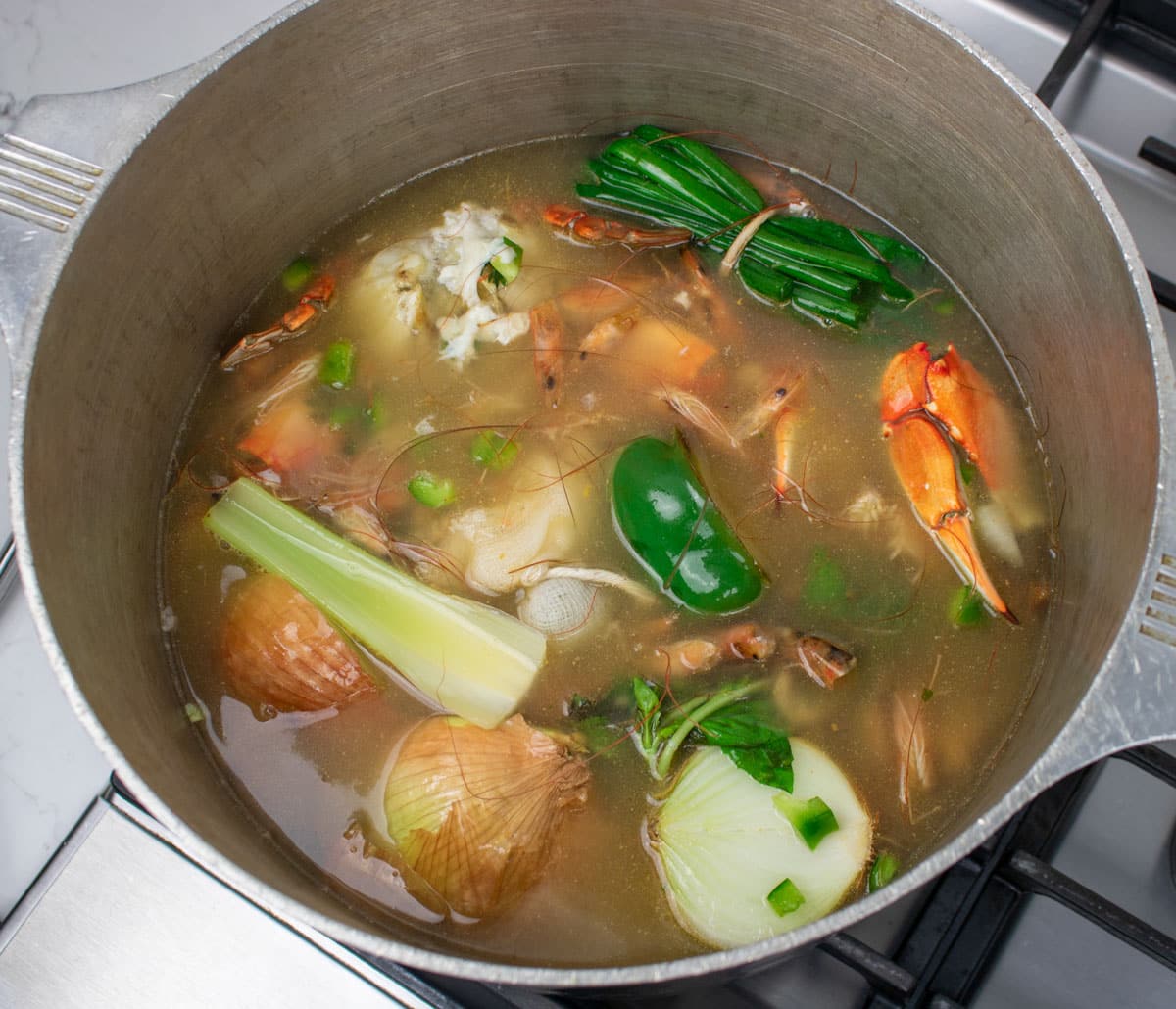 seafood stock simmering in a stockpot