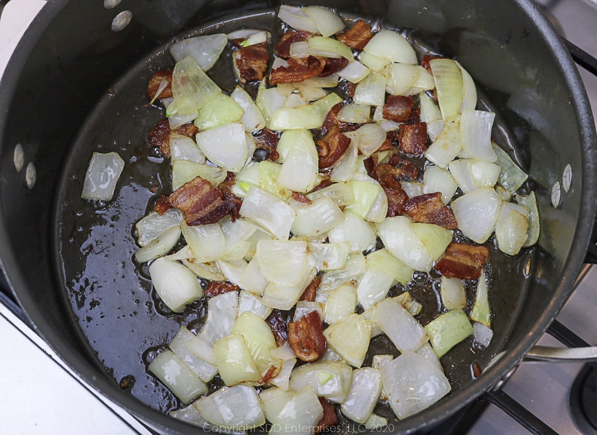 onions aand bacon frying in a dutch oven