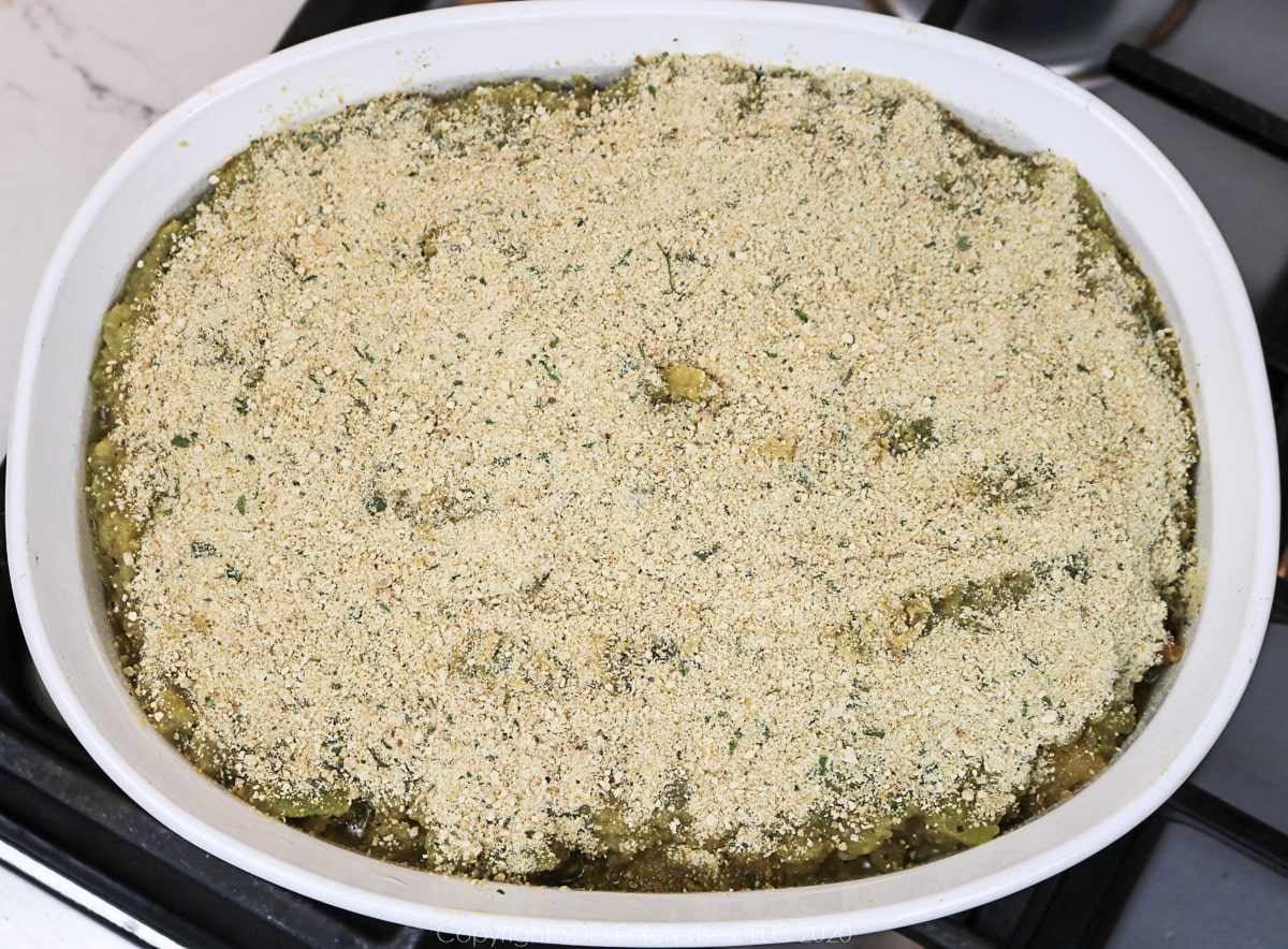 breadcrumbs sprinkled on a casserole of mirliton and shrimp