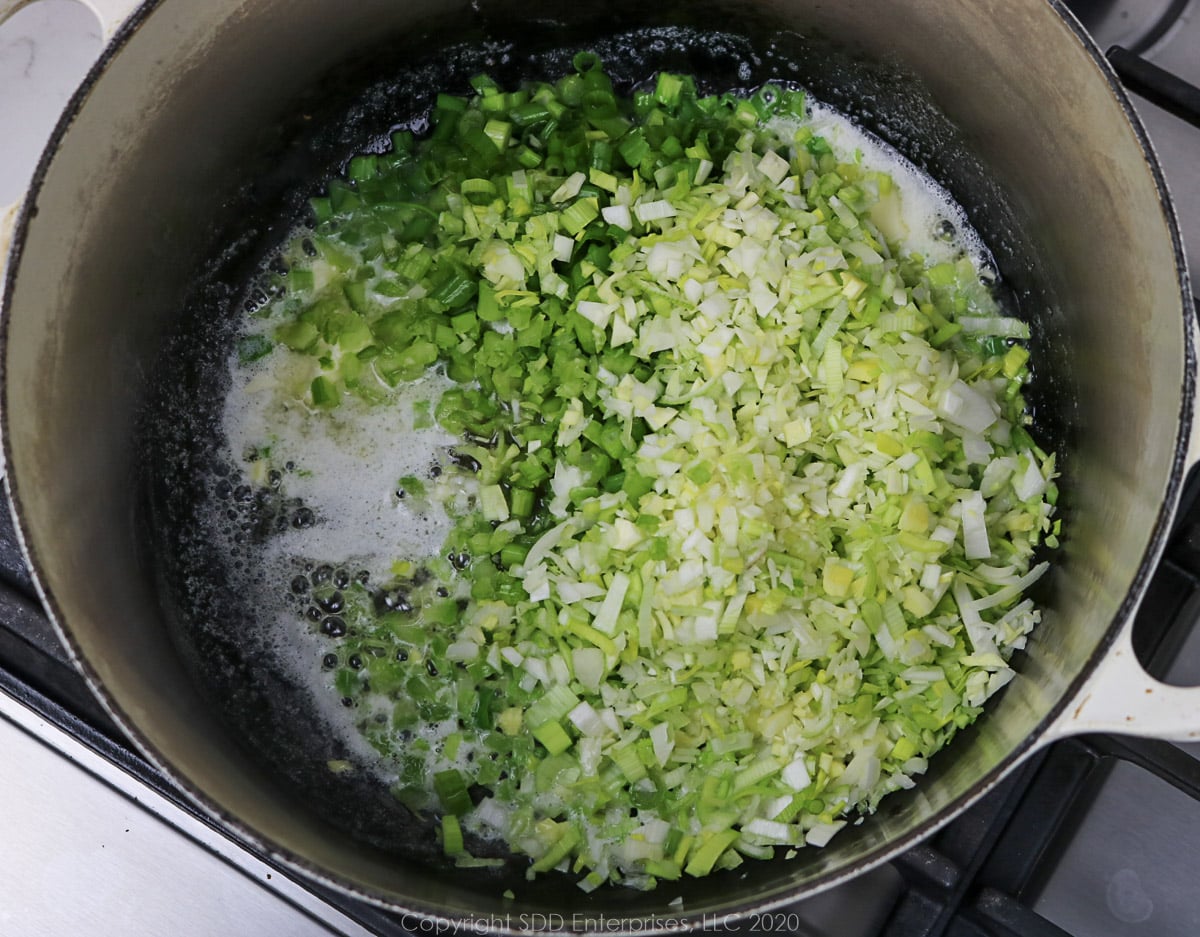 onions, leeks and celery simmering in butter in a dutch oven