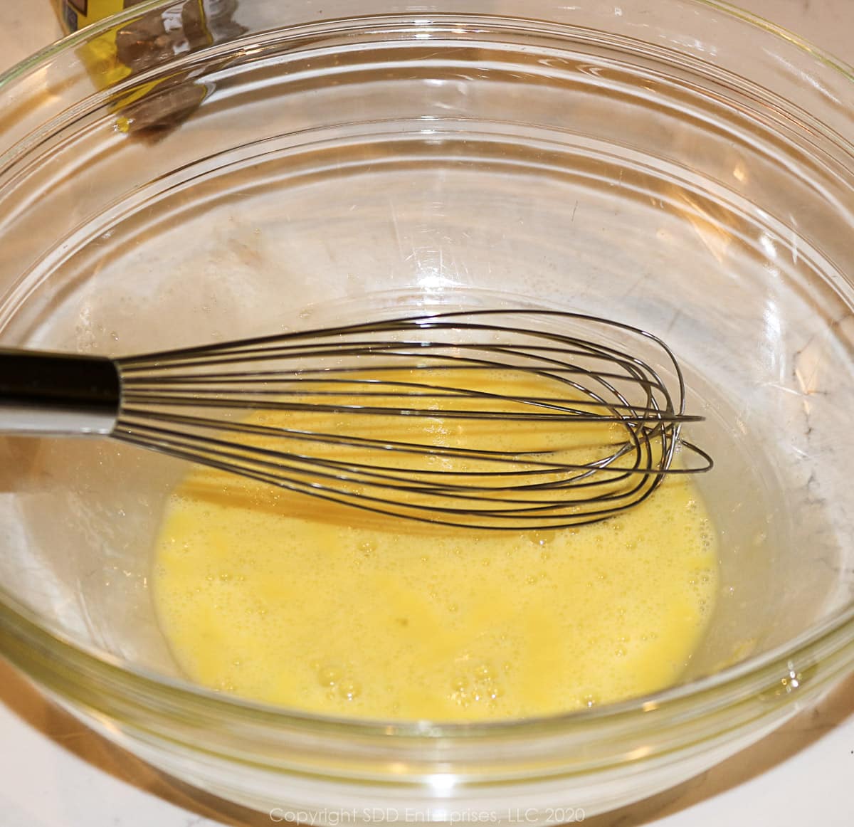 whisked egg in a glass bowl