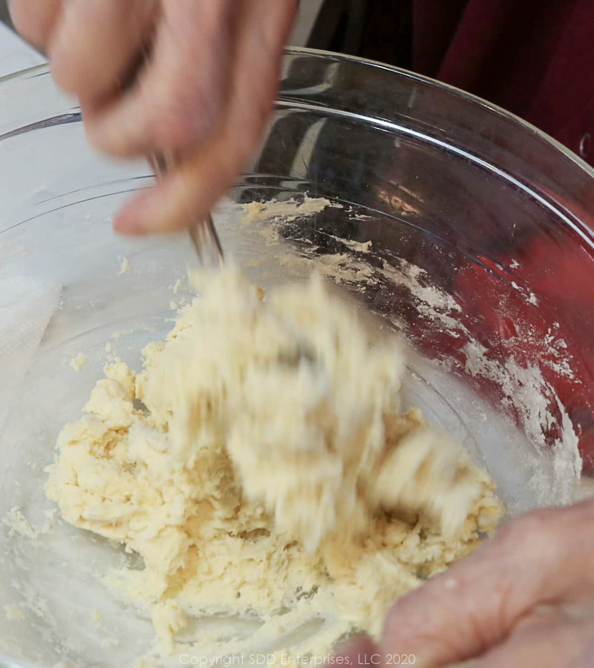mixing dough ingredients in a glass bowl