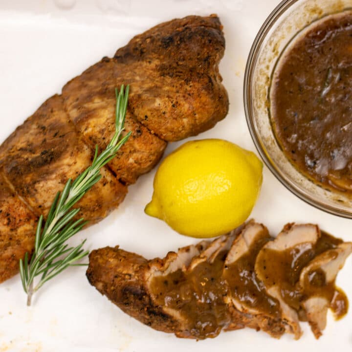 sliced and whole pork tenderloin with meyer lemon sauce and a lemon