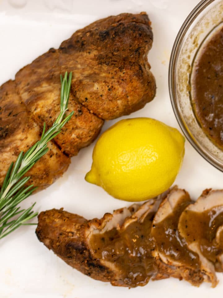 sliced and whole pork tenderloin with meyer lemon sauce and a lemon