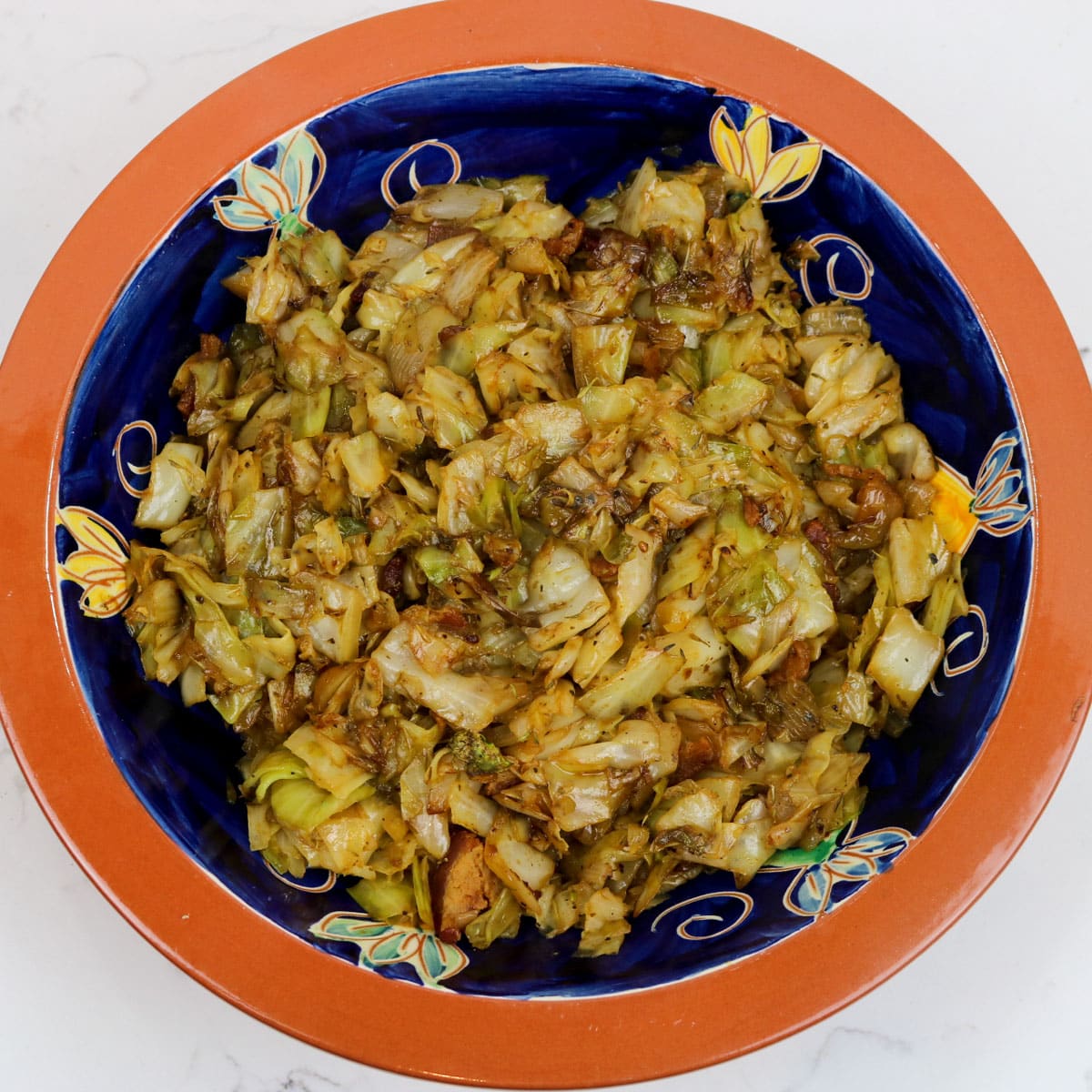 fried cabbage with bacon and cane syrup in a decorative bowl