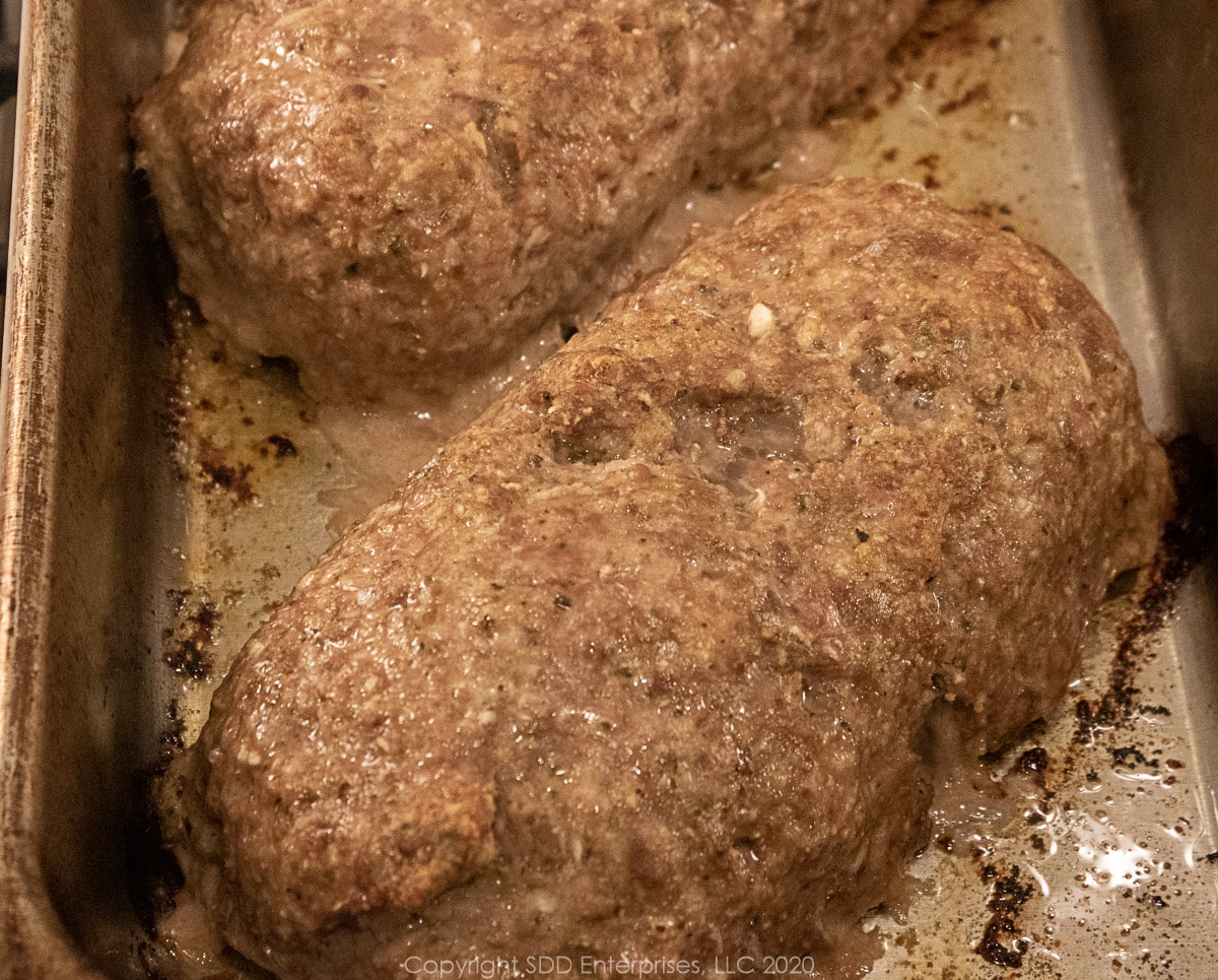 partially baked meatloaves in a baking pan