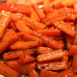 roasted carrots with cane syrup on a baking sheet