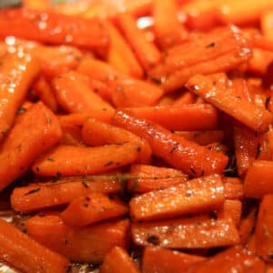 roasted carrots with cane syrup on a baking sheet