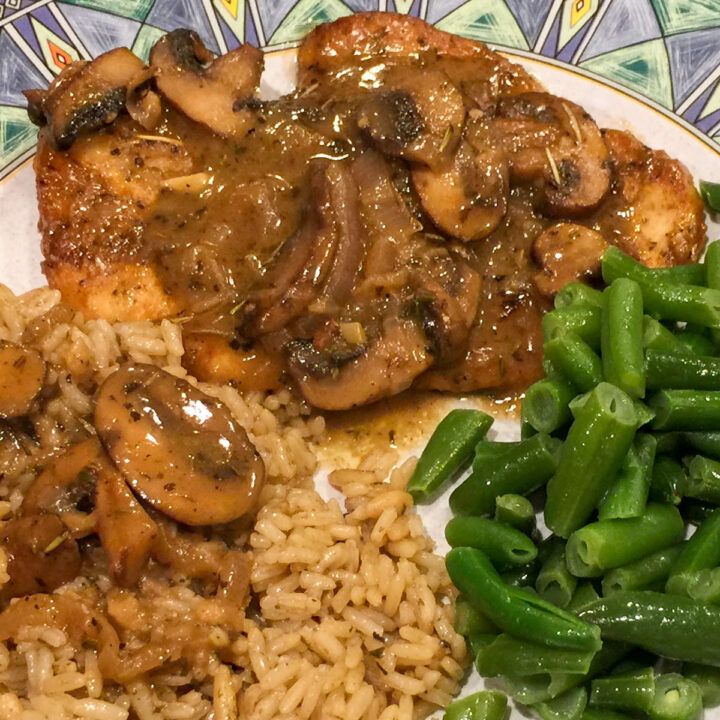 chicken marsala with mushrooms on a plate with rice and green beans