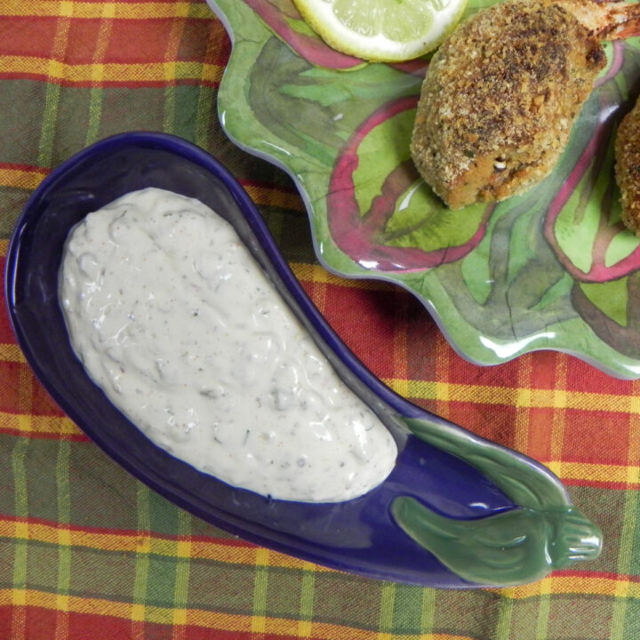 creole tartar sauce in a snall serving bowl with stuffed shrimp on the side