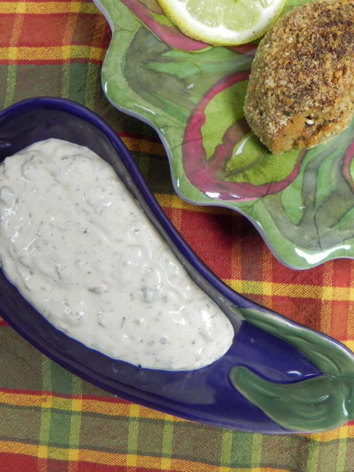 creole tartar sauce in a snall serving bowl with stuffed shrimp on the side