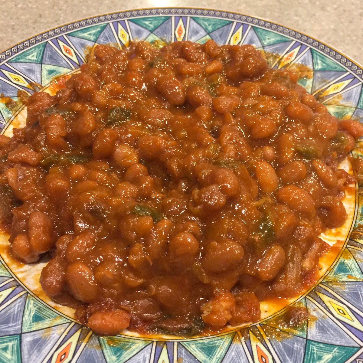 baked beans on a blue-green plate
