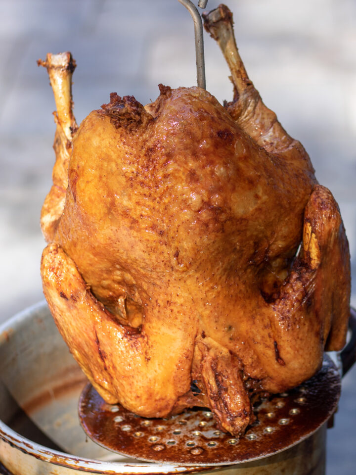 cajun fried turkey coming out of the oil