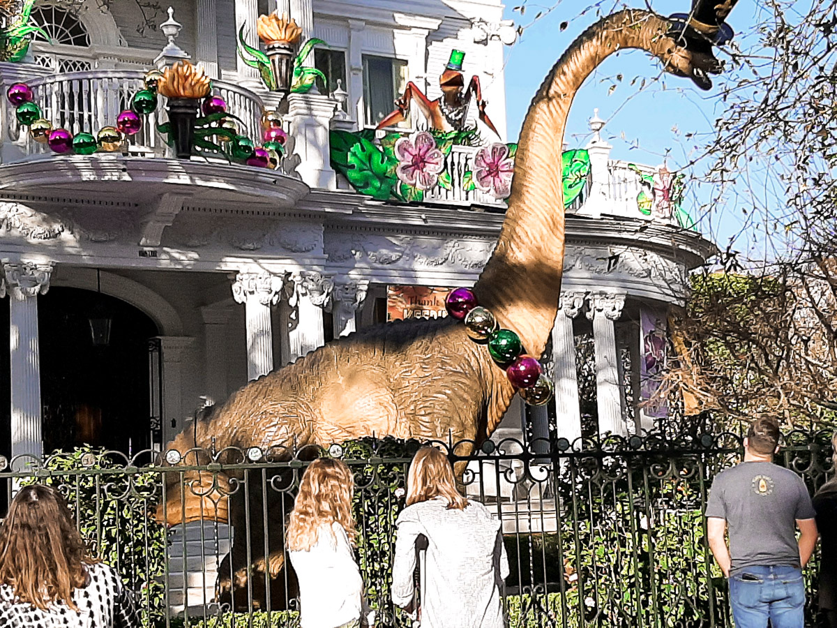 House Float on S Charles Ave with Dinosaur