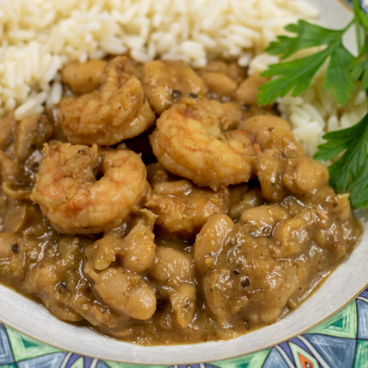 white beans and shrimp with rice and garnish in a bowl