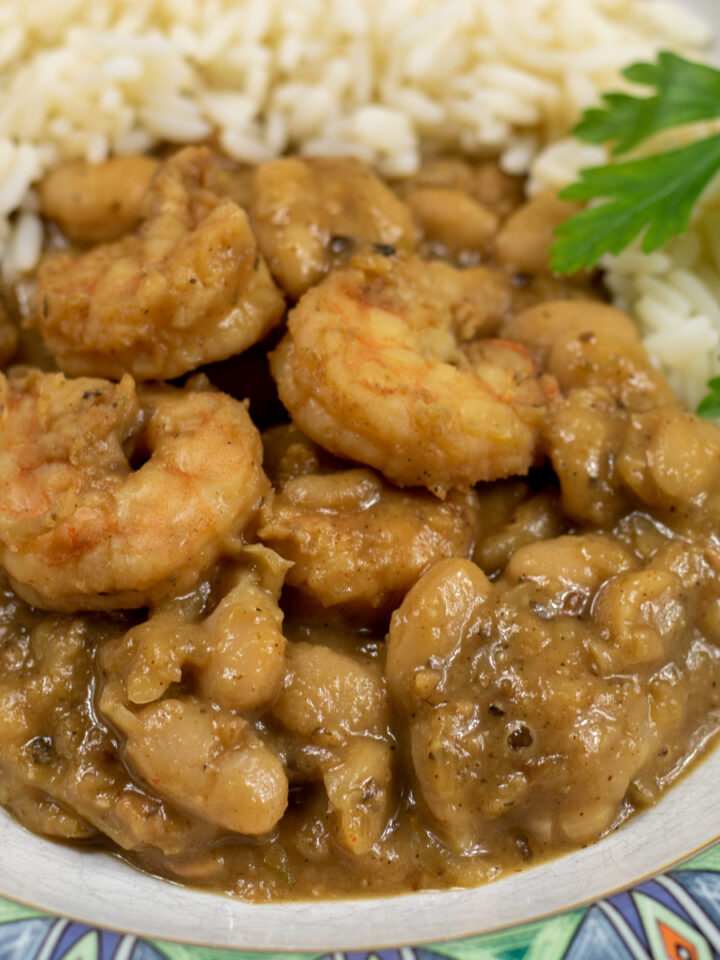 white beans and shrimp with rice and garnish in a bowl