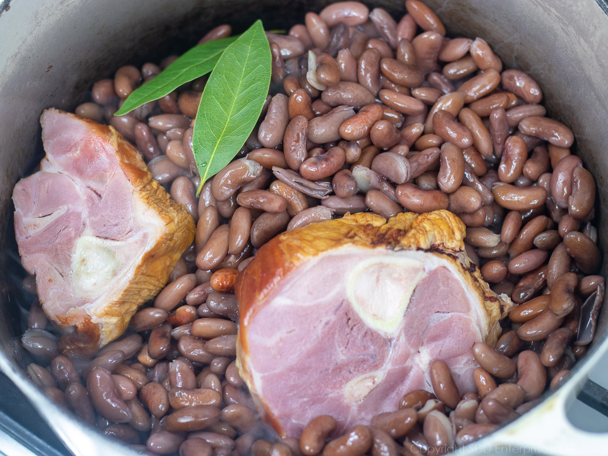 dry beans, smoked ham shank and bay leaves added to a Dutch oven