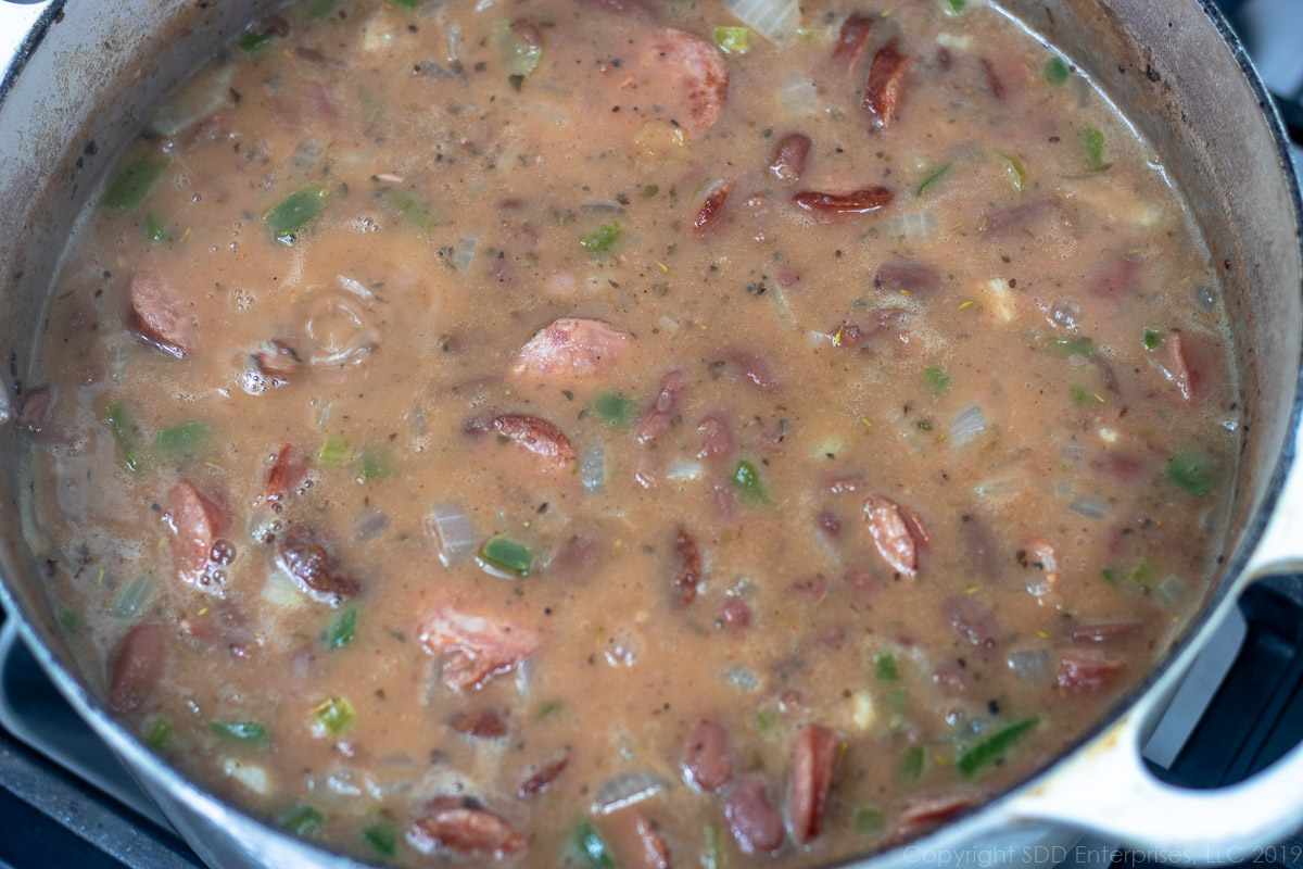 red beans simmering in a Dutch oven