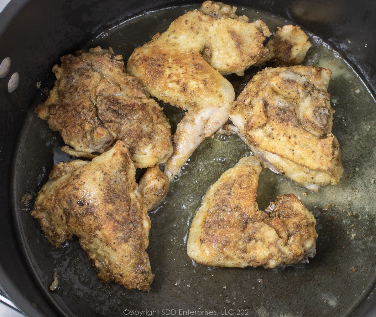 browning chocken pieces in a Dutch oven