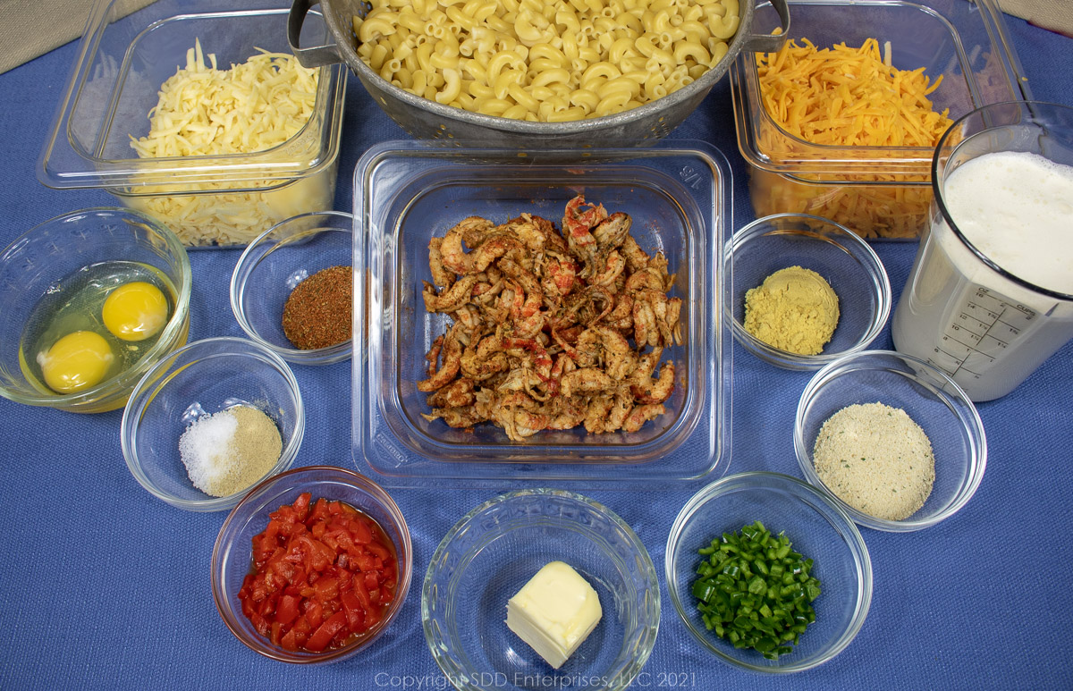 Prepared ingredients in prep bowls for crawfish mac and cheese.