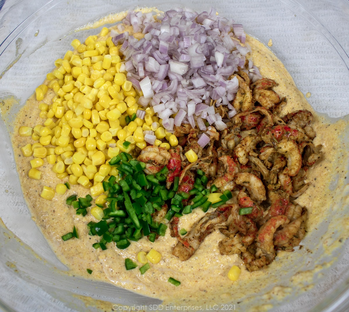Corn, crawfish tails and onions being combined with batter