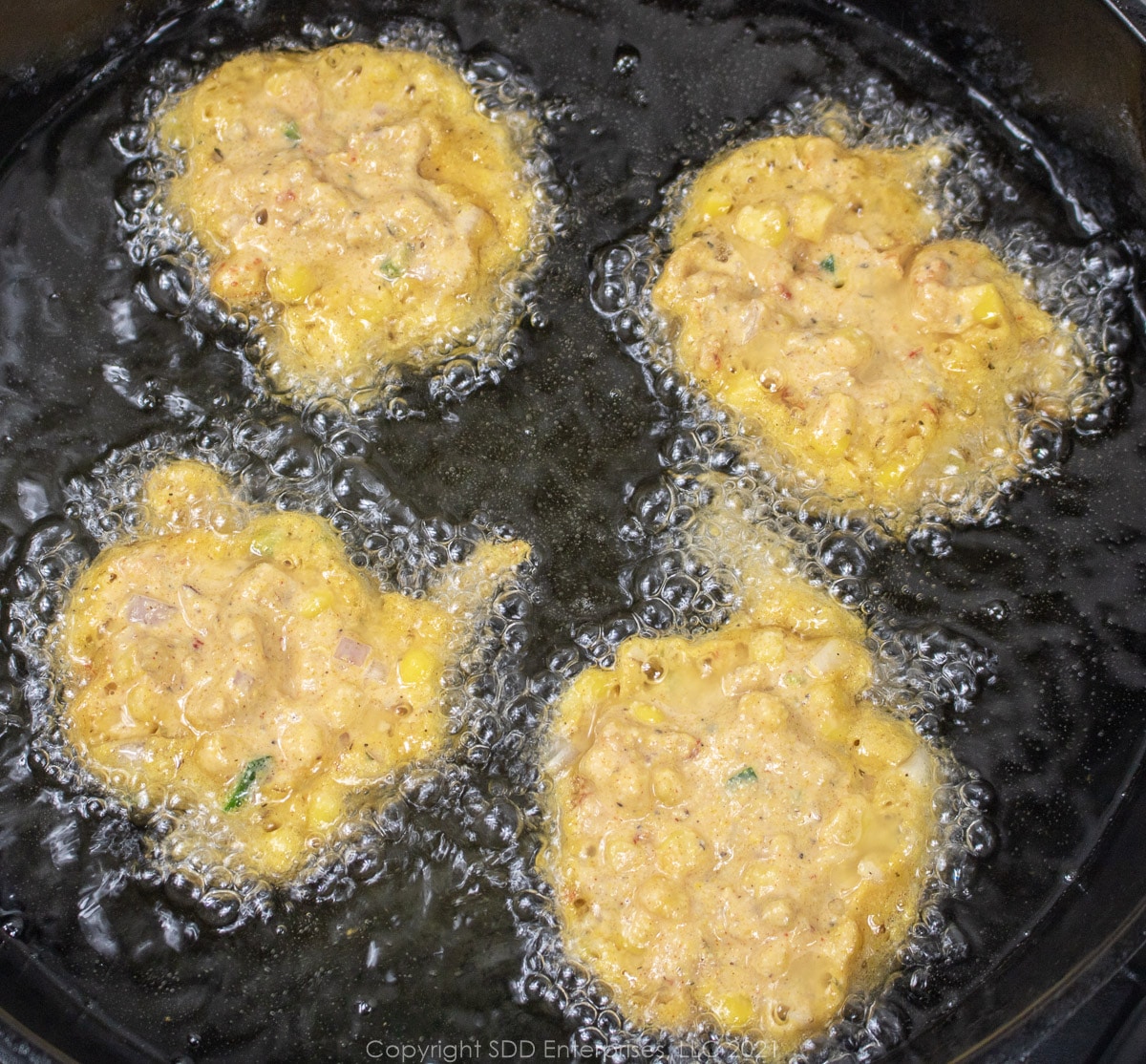 fritter batter frying in hot oil