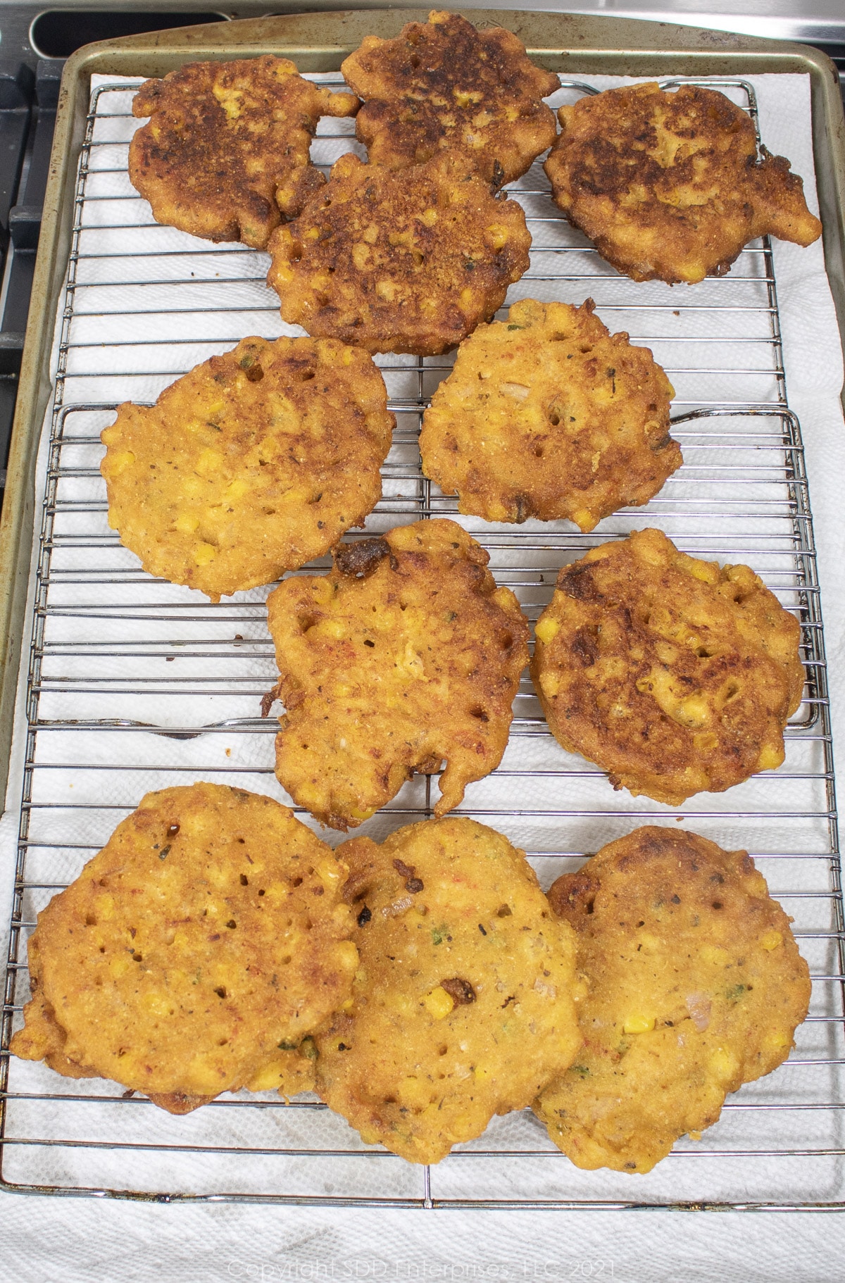 crawfish and corn fritters on a cooling rach