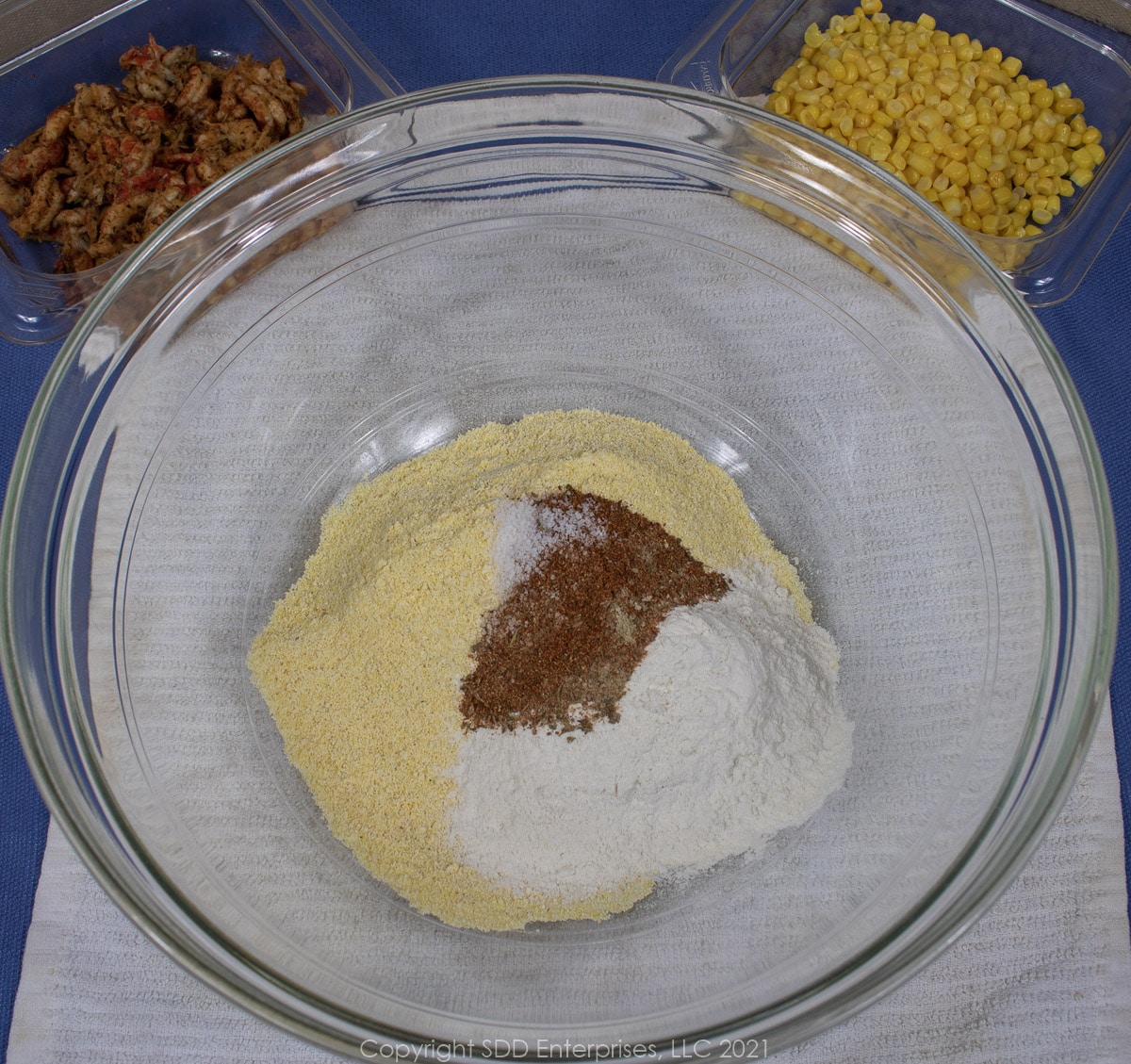 flour, corn meal and seasonings in a glass bowl