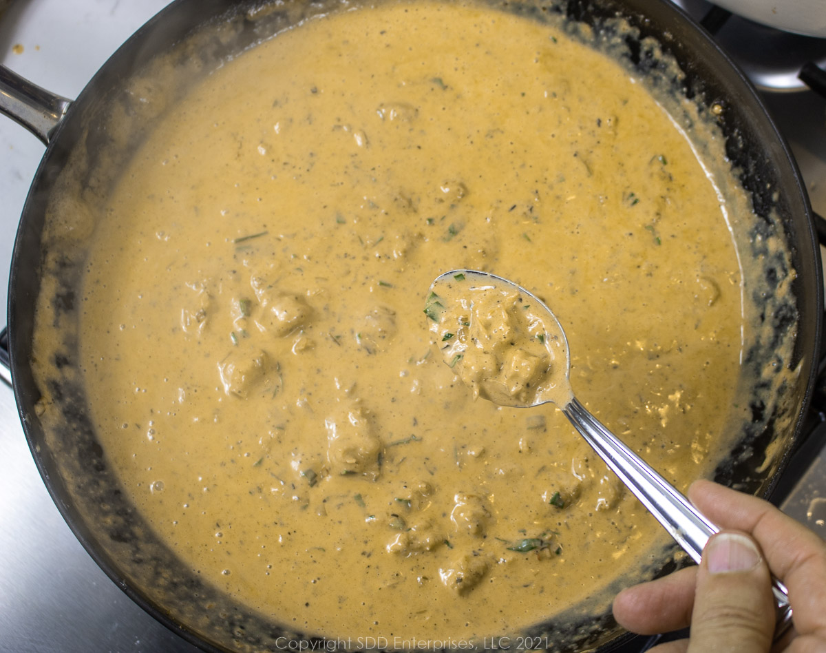 Crawfish Cream Sauce in a frying pan and on a spoon