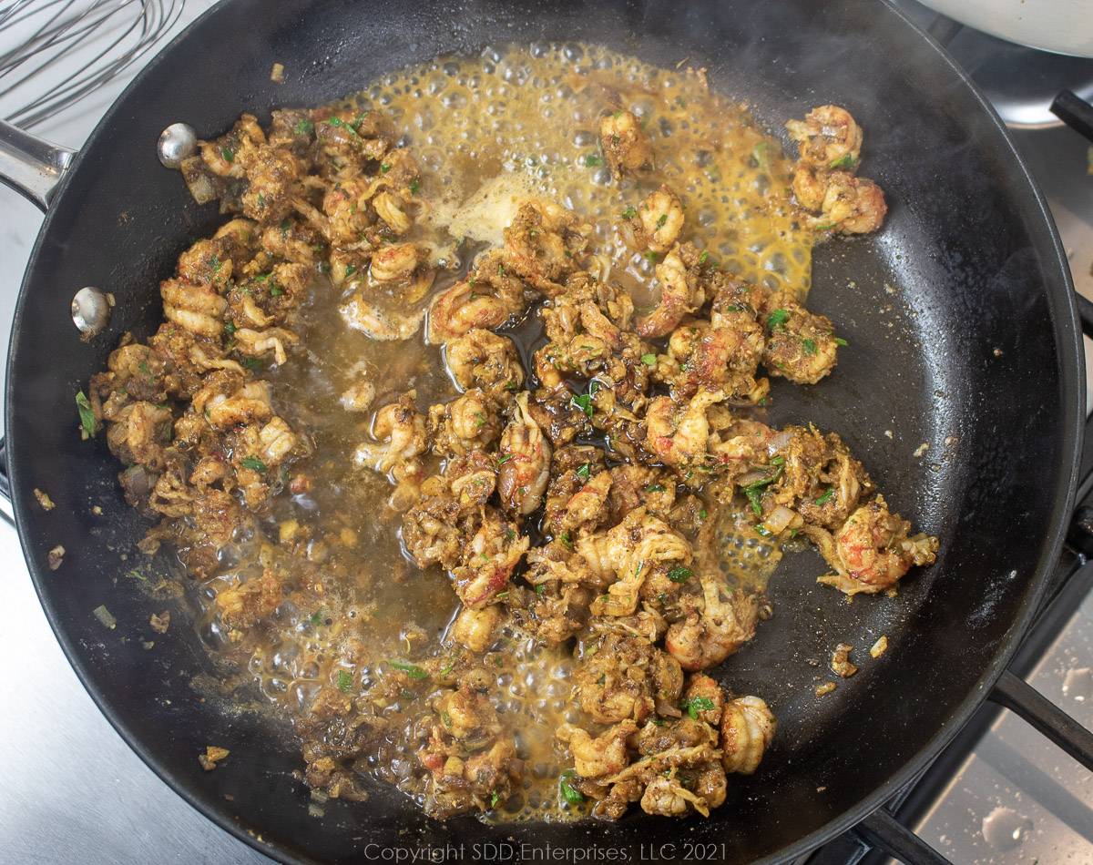 Sherry, Worcestershire simmering with crawfish tails and shallots in a frying pan