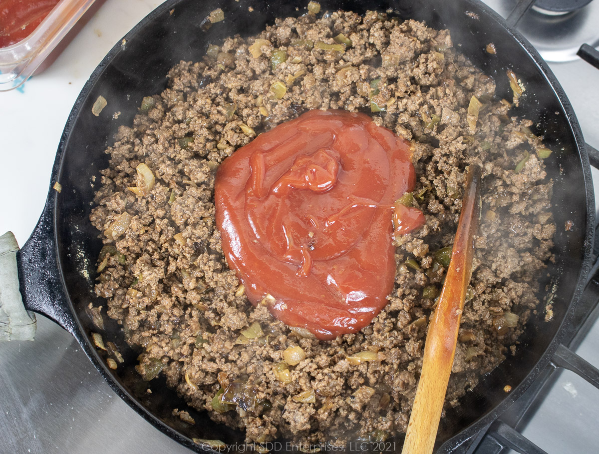 Ketchup and Worcestershire added to browned beef and spices