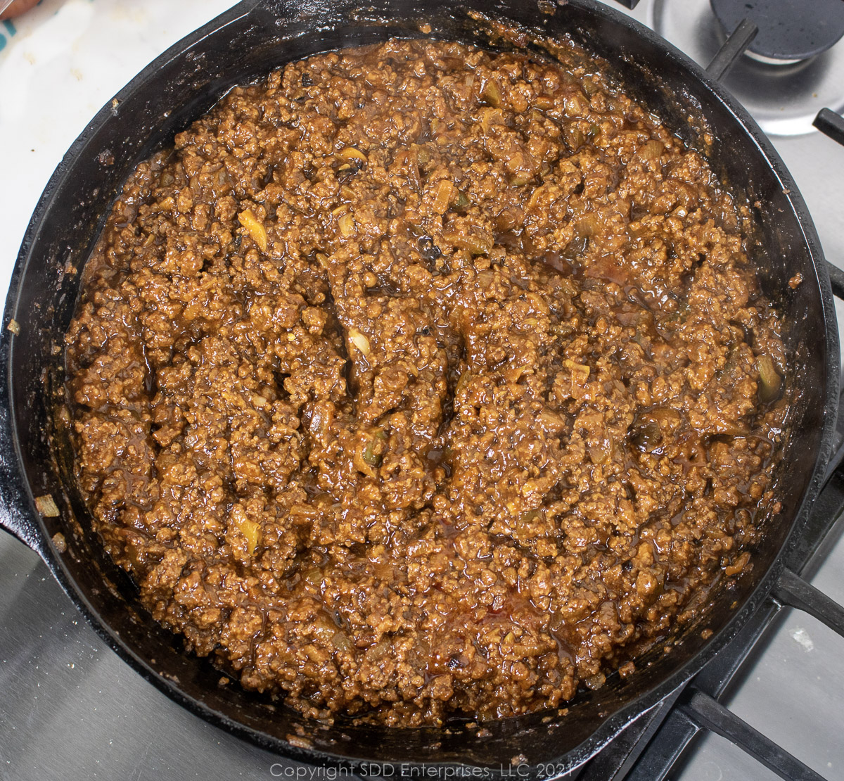 Sloppy Joe mixture simmering in a cast iron pan