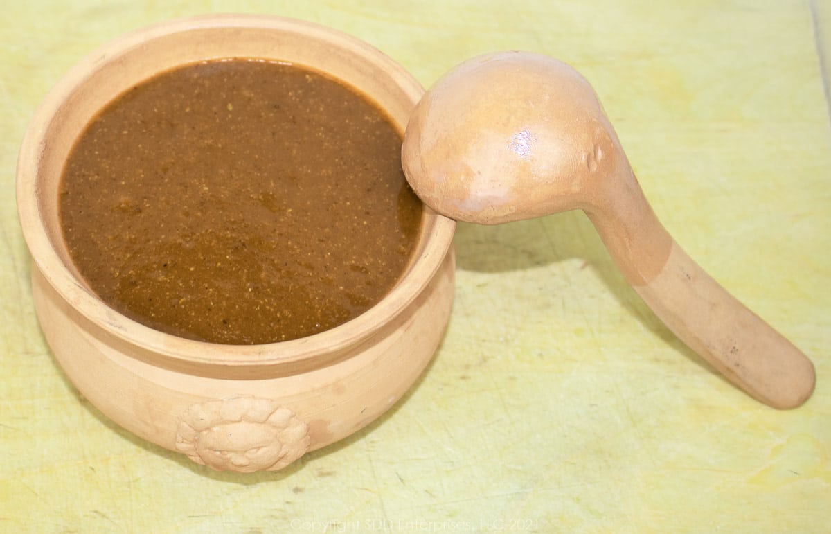 bbq sauce in a clay serving bowl with ladle