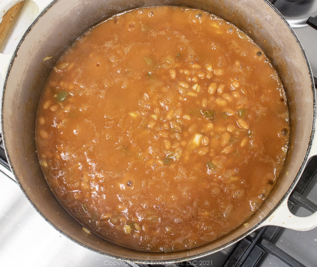 canned beans and vegetables simmering in a Dutch oven